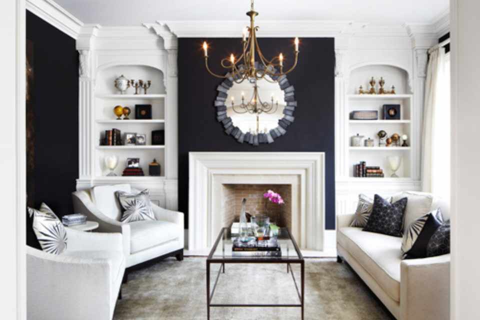 designer home with matte black details, arched bookshelves and gold chandelier